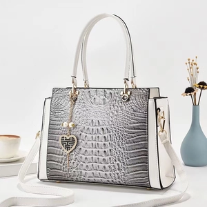 Gray crocodile texture shoulder bag with embossed detail and white contrast handles
