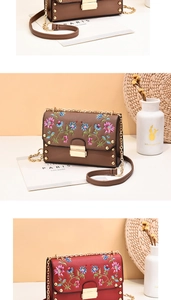 Detailed close-up of vintage floral embroidery and gold chain straps on trendy PU handbags