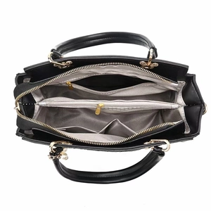 Interior view of black crocodile pattern tote bag showing multi-pocket storage space