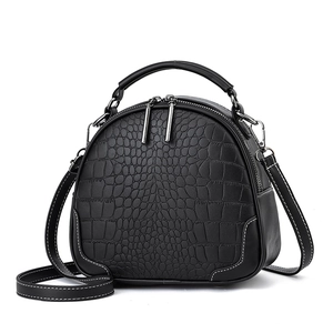 Minimalist black crocodile embossed round handbag with silver hardware and contrast stitching