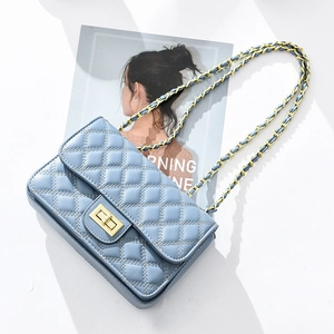 Light blue quilted chain bag with gold hardware and stylish turn-lock closure