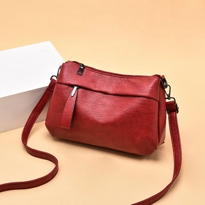 Stylish red soft PU leather crossbody bag for women with front zipper and silver hardware