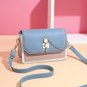 Blue and cream leather crossbody bag with cute cat-shaped lock and gold chain strap