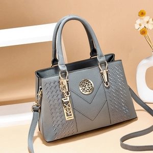 Elegant grey lychee leather handbag with woven panels and adjustable shoulder strap