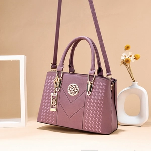 Elegant purple leather handbag for women featuring gold hardware and stylish M stitching
