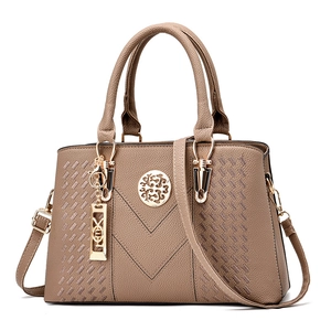 Deep beige women's handbag with V-shaped stitching and gold metallic charms