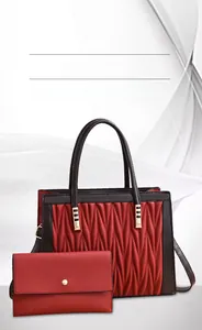 Detail view of red pleated leather tote bag set with matching rectangular wallet and gold hardware