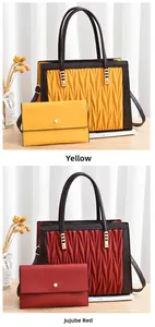 Detail view of yellow and jujube red handbags with wave texture and gold hardware set