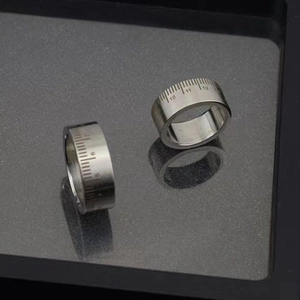 Detailed macro view of silver stainless steel rings featuring engraved ruler scale numbers