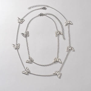 Silver butterfly layered necklace with intricate hollow pendants and adjustable chain