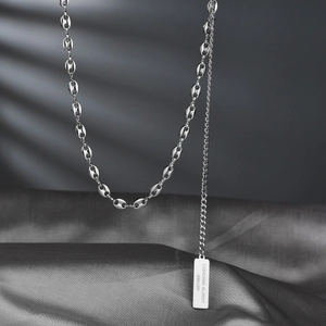 Silver stainless steel pig nose link necklace with rectangle pendant on grey silk background