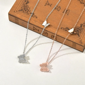 Minimalist double butterfly necklace in silver and rose gold on a vintage wooden box