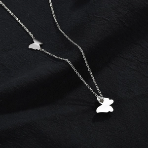 Elegant silver double butterfly pendant necklace on a minimalist fine link chain