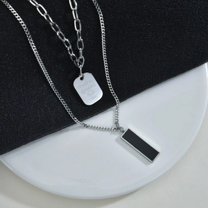 Double-layered titanium steel necklace featuring a rectangular engraved pendant and black bar