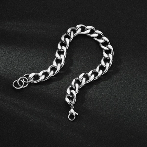 Macro view of polished stainless steel Cuban link chain with lobster clasp detail