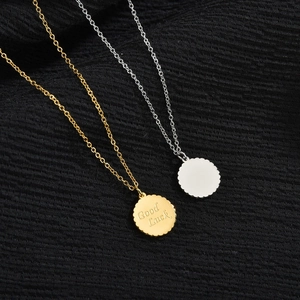 Minimalist Good Luck coin pendant necklace in gold and silver finishes on black fabric