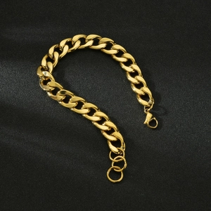 Close-up of golden Cuban link bracelet with lobster clasp on black background