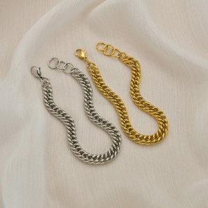 Polished titanium steel curb chain bracelet set in silver and gold with lobster clasp