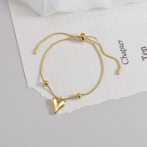 Gold heart pendant bracelet with adjustable twisted rope chain and polished finish