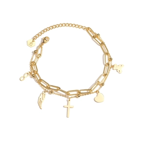 Detail of gold double-layer bracelet with heart, bear, and feather charms and logo tag
