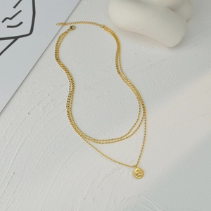 Three-layer gold coin pendant necklace with embossed angel on a white background