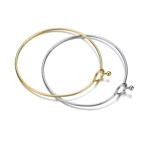 Minimalist titanium steel coil bracelets in gold and silver with ball clasp closure
