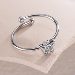 Adjustable silver butterfly ring with sparkling zircon inlays on a stone tray