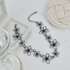 Artistic black hollow flower necklace with intricate mesh design and lobster clasp