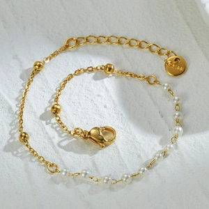 Elegant gold stainless steel bracelet with white pearls and small round beads