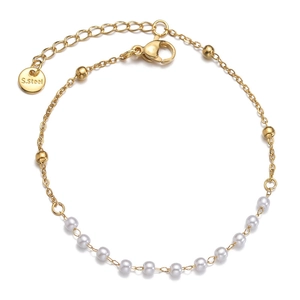 Elegant gold stainless steel bracelet featuring small white pearls and adjustable lobster clasp