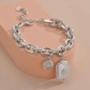 Minimalist silver chain bracelet with smiley face coin and baroque style charm