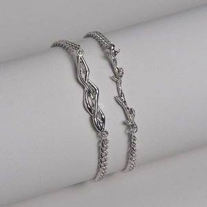 Minimalist stainless steel thorn bracelets with organic twisted texture and sleek flat chains