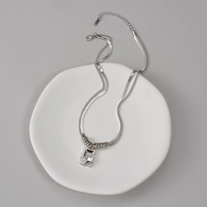 Double-layered silver necklace featuring a square zircon pendant on a snake bone chain