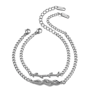 Minimalist stainless steel bracelet set featuring thorn and wave designs with curb chain