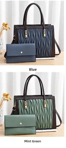 Detail of blue and mint green quilted tote bags with matching wallets on a wooden table