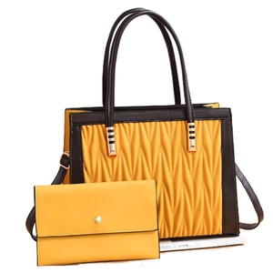 Fashionable yellow quilted tote and wallet set with brown trim on white background