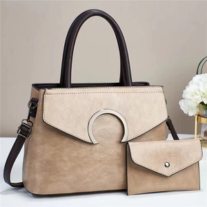 Detail view of khaki two-piece handbag set with pebble texture and adjustable strap