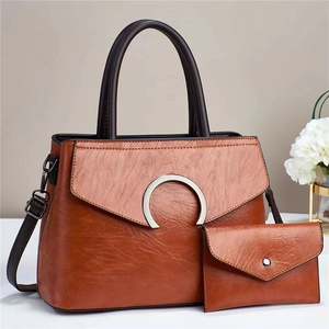 Brown contrast large capacity tote bag with matching envelope pouch on white display