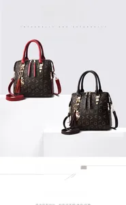 Detailed close-up of patterned PU leather tote bags with tassel and golden cat charms