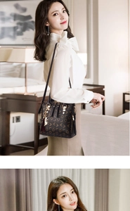 Close-up of golden hardware and cat charm detail on the printed PU leather shoulder bag