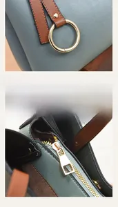 Close-up of light blue leather bag with brown handles and gold hardware details