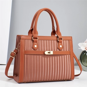 Brown leather handbag with vertical textures, top handle and adjustable shoulder strap