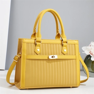 Elegant yellow PU leather handbag with vertical textures and gold clasp shown from side angle