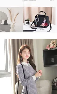 Détail de broderie florale sur sac à main en cuir PU noir avec poignée en anneau