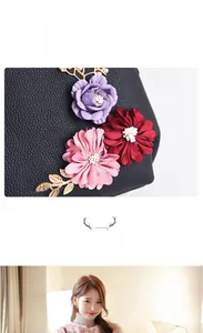 Gros plan du sac à bandoulière en cuir grainé noir avec broderie florale colorée