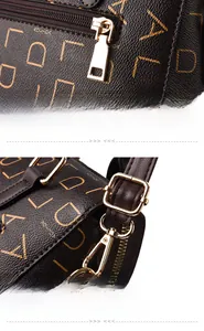 Close-up of golden zipper pull and metal swivel hook on dark brown patterned PU leather