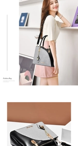 Detail of checkered tote bag with gold butterfly charm and detachable leather strap
