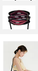 Detail view of large handbag interior with multiple compartments and red fabric lining