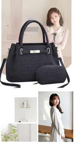 Détail du sac cabas noir motif crocodile avec fermoir doré et petit porte-monnaie