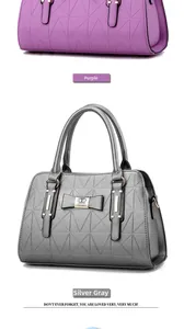 Detail of vintage geometric triangle embossed handbag with metal bow clasp decoration